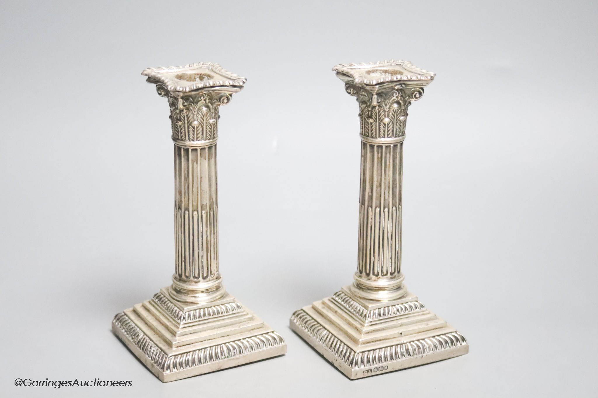 A pair of late Victorian silver Corinthian column dwarf candlesticks, Atkin Brothers, Sheffield, 1899, 17.6cm, weighted.